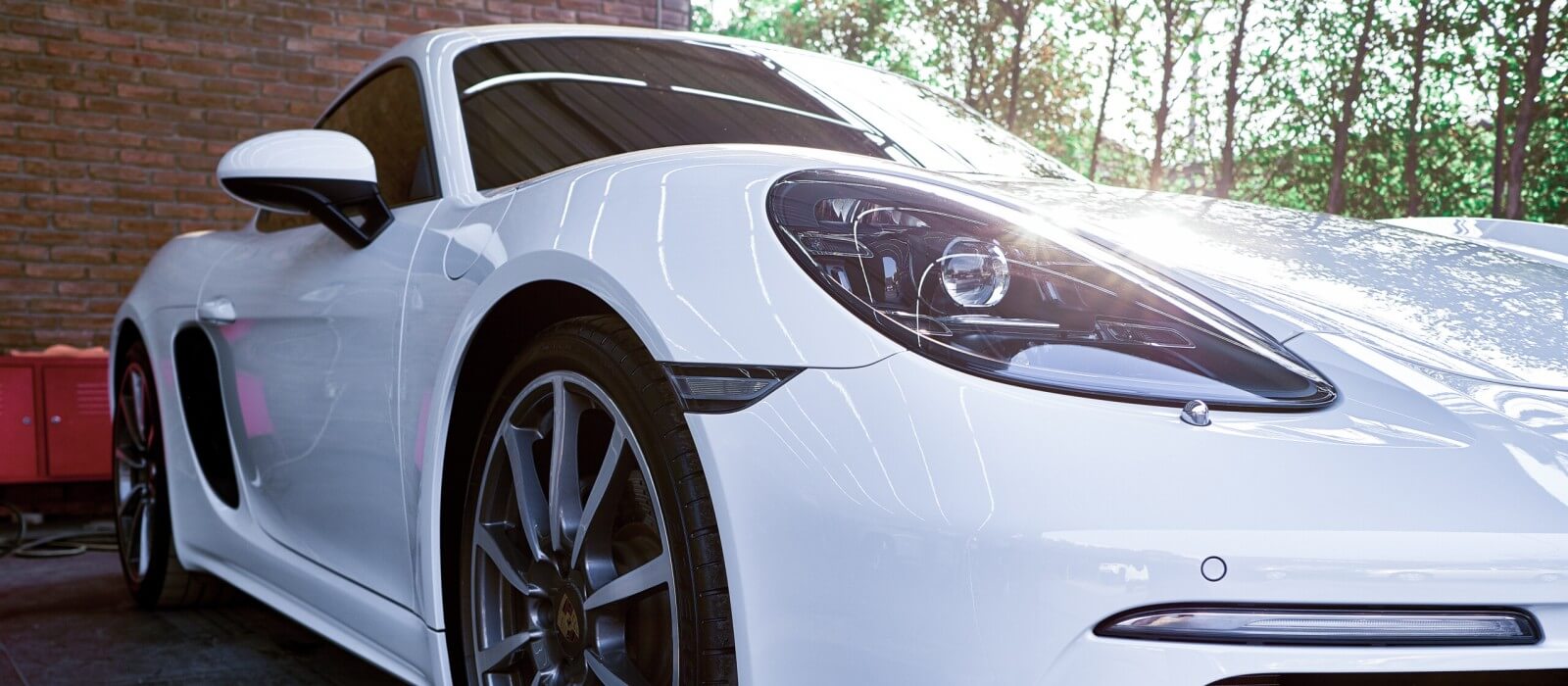 White car showing reflected light across its glossy paint
