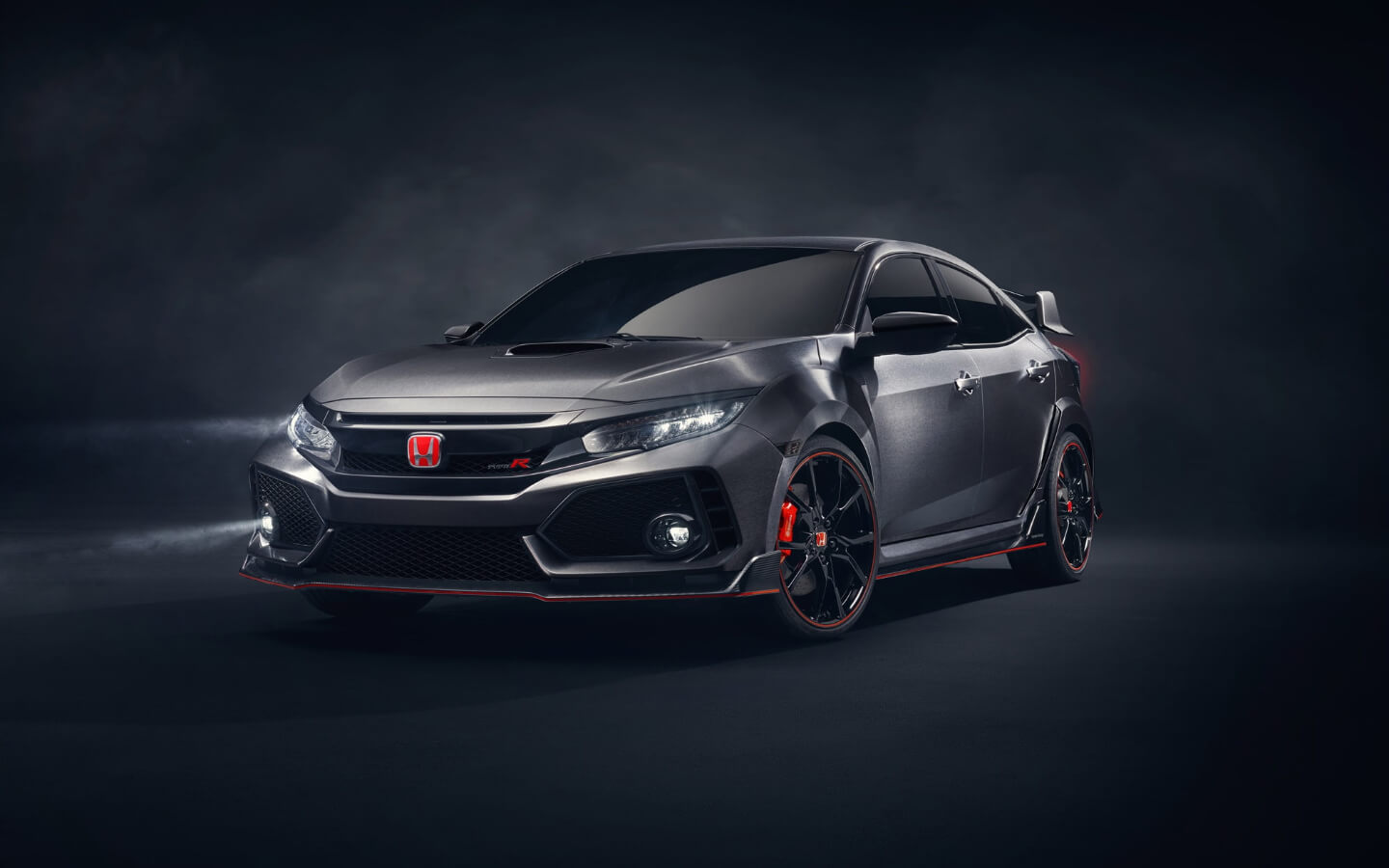 Dark Honda Civic showing its front and side bodywork