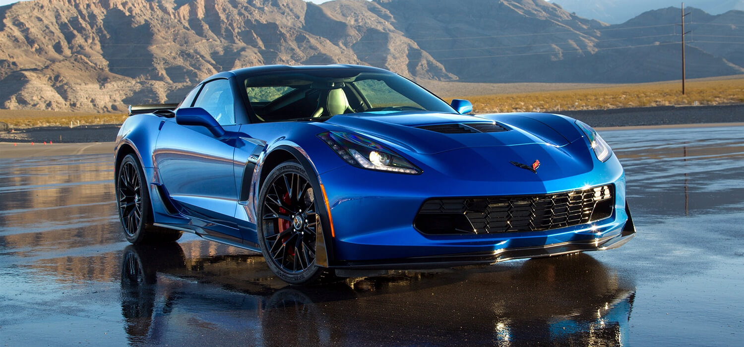 Blue Chevrolet Corvette C7 coupe with dark roof and front vents