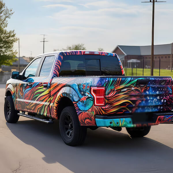 Colorful custom graphics covering the side and tailgate of a pickup truck