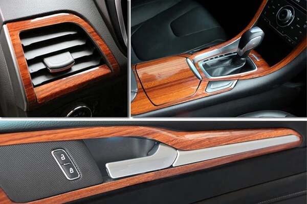 Wood-look finish across a vent surround, center console and door insert