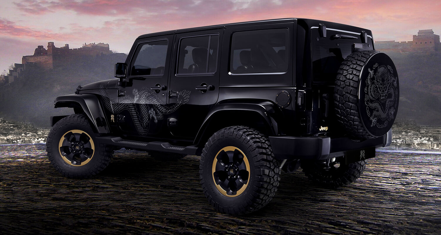 Black Jeep Wrangler showing doors, hardtop and rear-mounted spare tire
