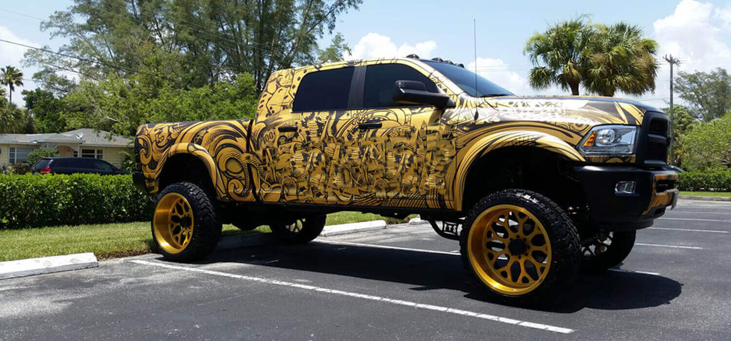Pickup with patterned vinyl graphics across the cab and exterior bed