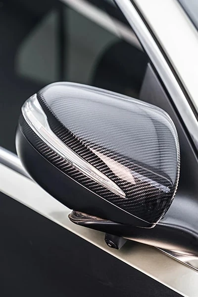 Mirror cap with a glossy carbon-pattern appearance