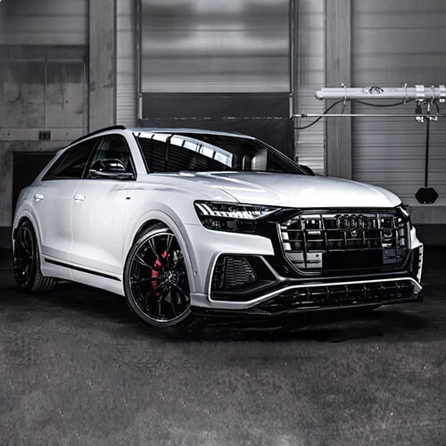 White SUV with dark window, mirror and grille accents