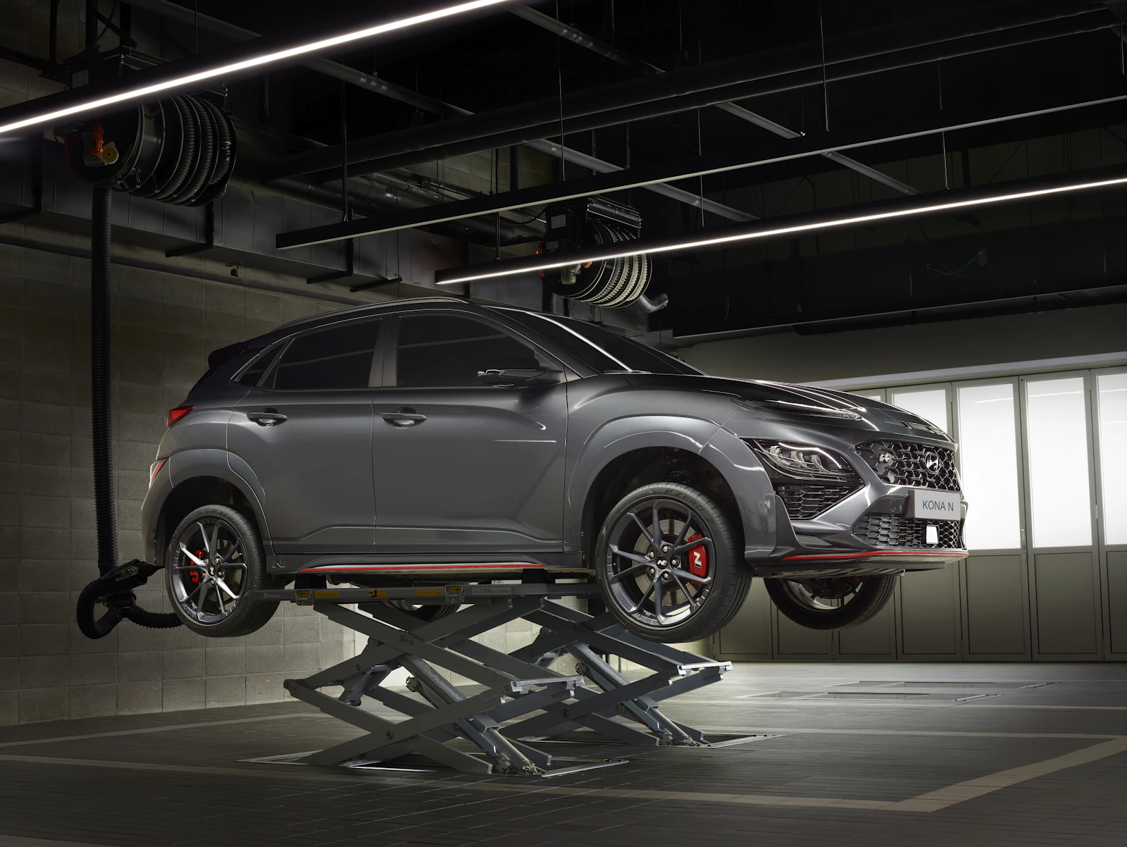 Vehicle raised on a workshop lift for underbody access