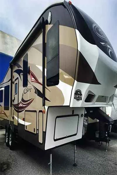 Fifth-wheel trailer with sweeping brown graphics across cream side panels